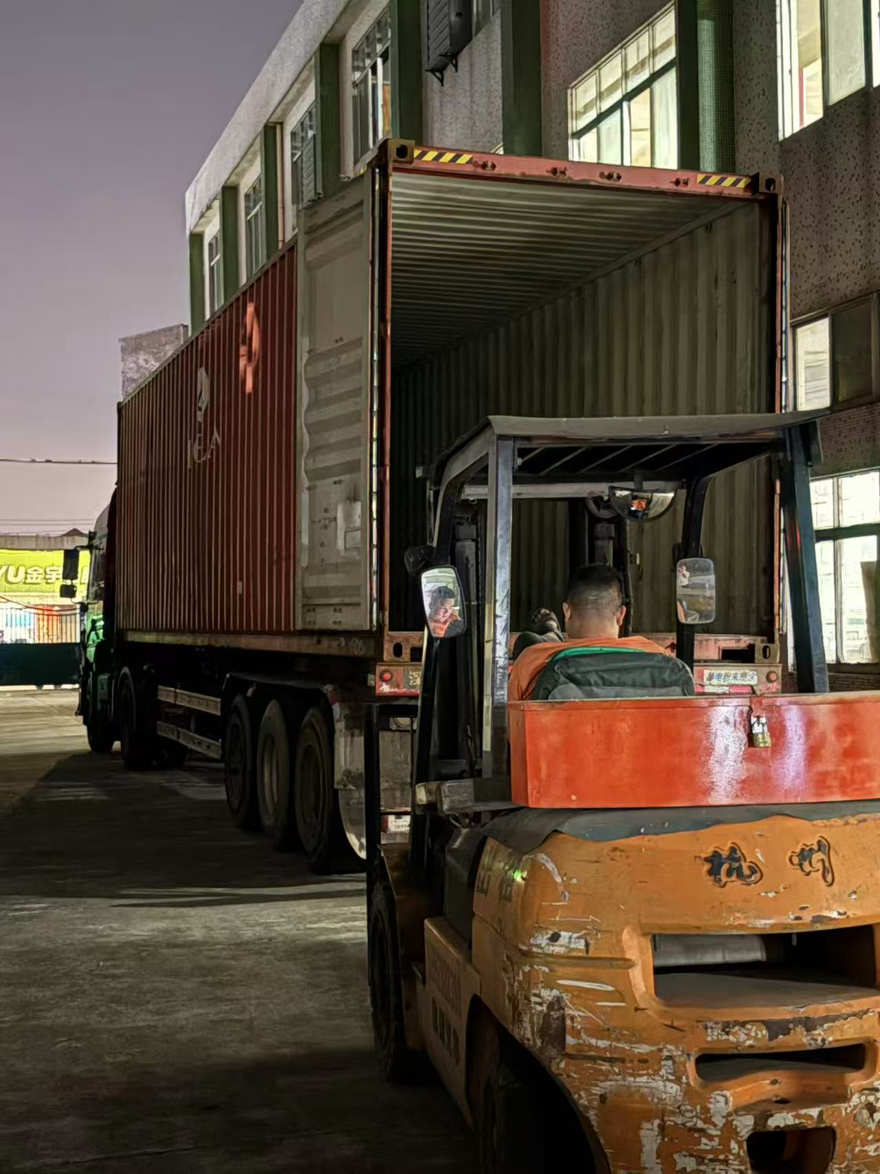 Forklift loading furniture into the container at the factory